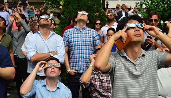 People watching solar eclipse while wearing special glasses